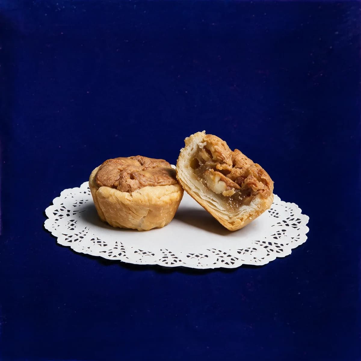 Classic Pecan tassies, one whole and one cut in half